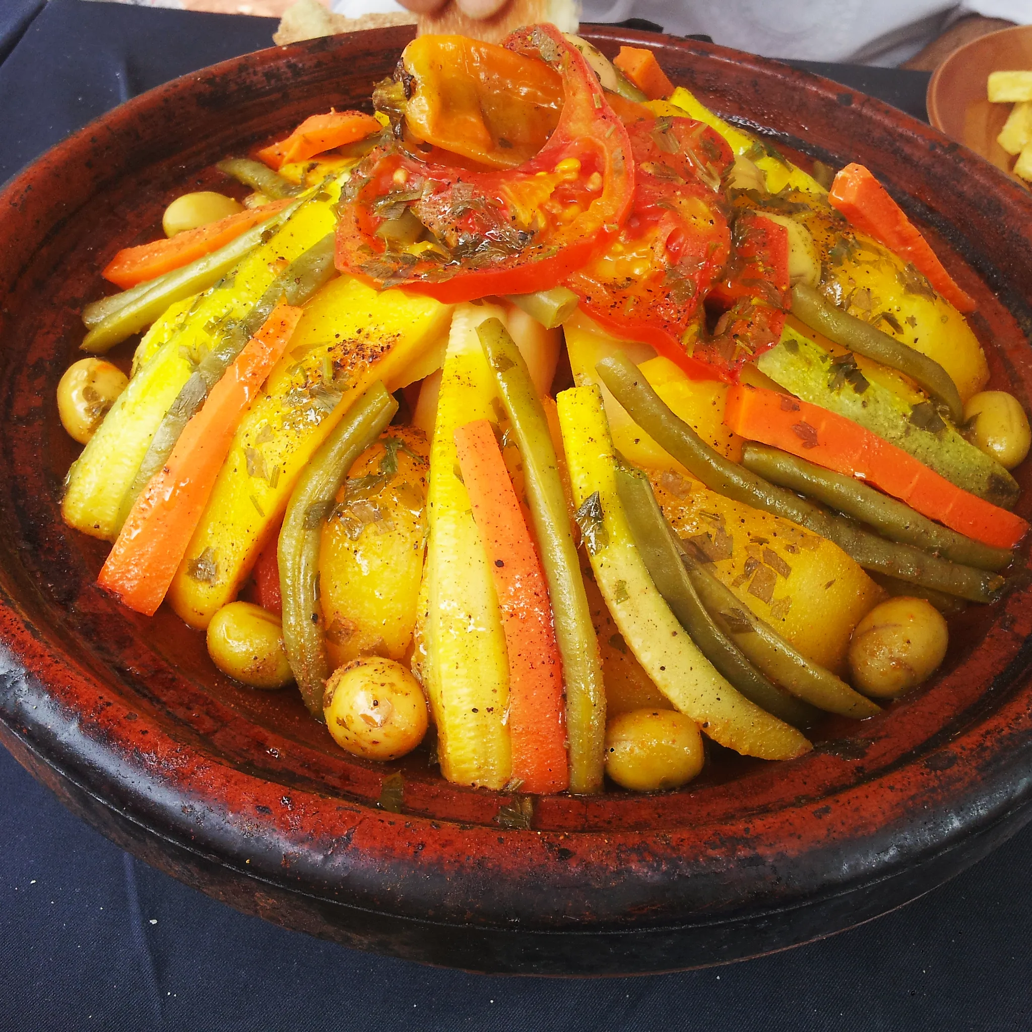 A tagine on a table with bread